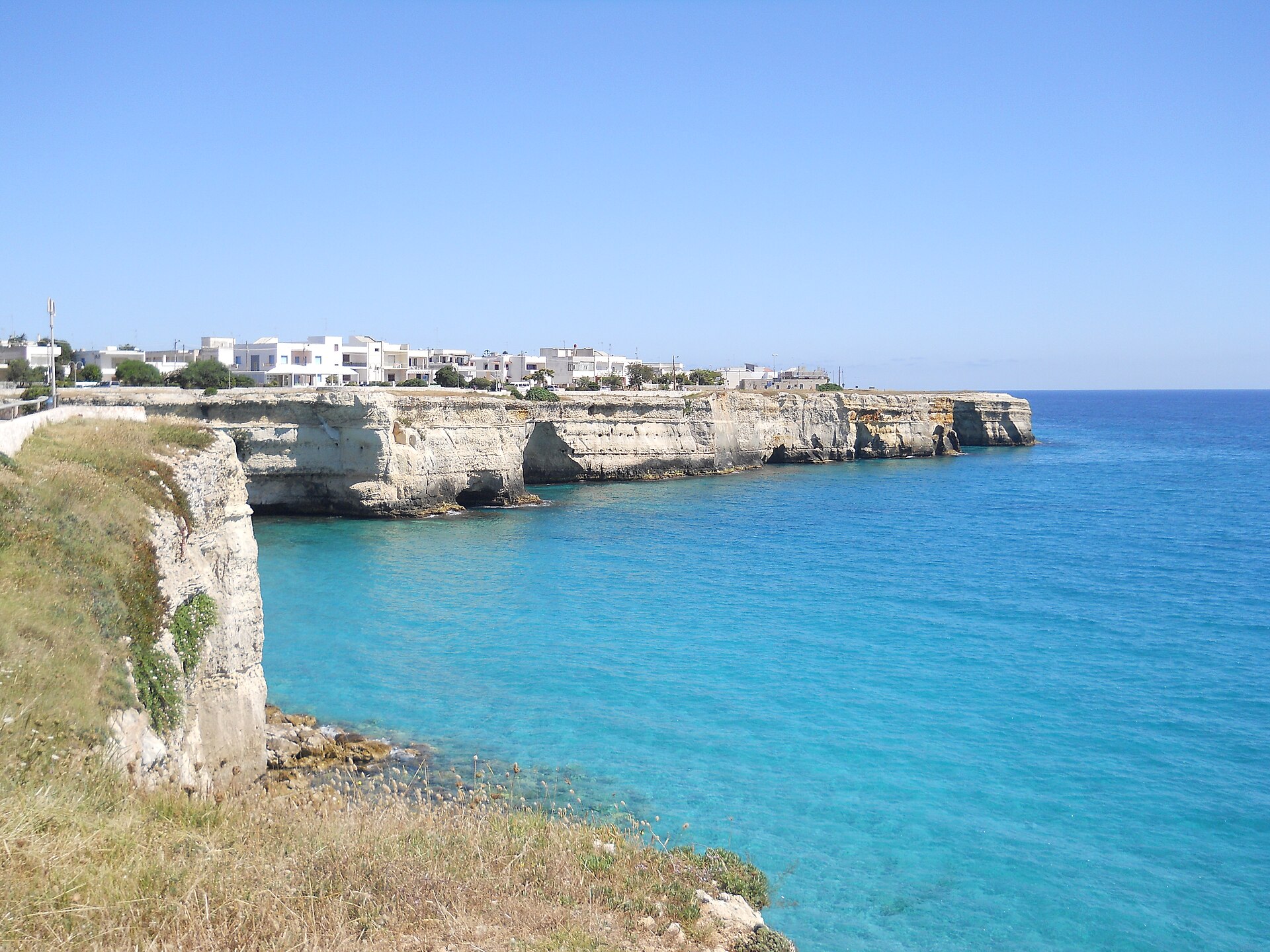 Turquoise water below the white cliffs of Torre dell'Orso